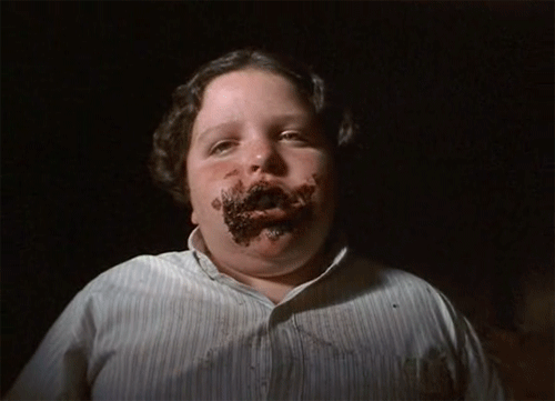 Boy eating large chunks of chocolate from "Matilda" A kids' entertainment movie