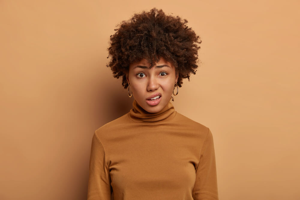 puzzled-african-american-woman-has-displeased-expression-frowns-face-looks-with-disgust-something-unpleasant-dressed-casual-wear-isolated-brown-wall-emotions-reaction-food-neophobia-diet234